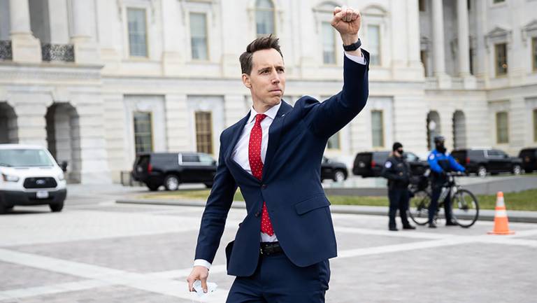 Senator Josh Hawley raising his fist in support of a crowd gathering at the US Capitol on Jan. 6, 2021. Image from https://www.kansascity.com/news/politics-government/article248354085.html