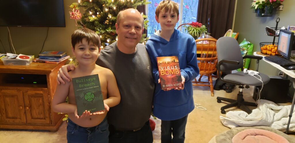 Dec. 6, 2018. a high point in my publishing journey. Left to right - Zeke with "Bullseye Breach," me - Grandpa, and Elijah with "Virus Bomb." Elijah titled "Virus Bomb" in third grade. "It has computer viruses, biological viruses, and bombs, right? How about 'Virus Bomb?'" Nobody came up with anything better.