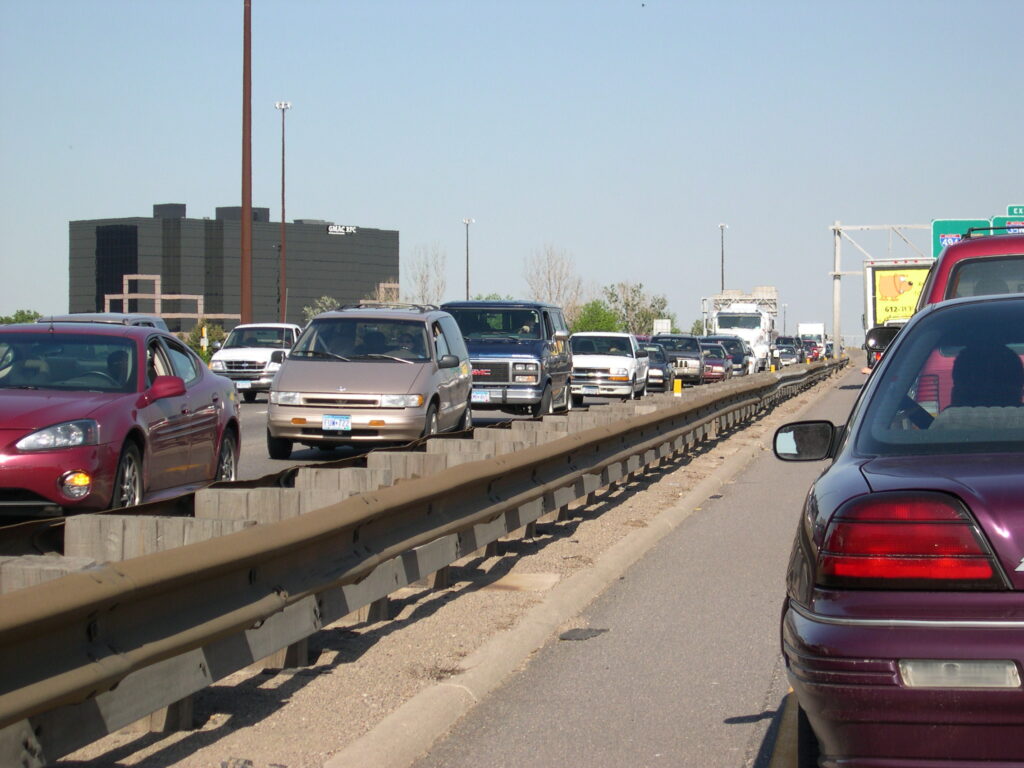 Driving home in stop and go traffic in May, 2004. I was stopped when I stuck the camera out a window and snapped this picture. Dell demands its employees return to this insanity.